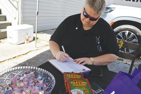 Abigail Blythe Batton/Staff Correspondent Rotarian Trevis Hicks prepares for the final draw during Saturday’s Rotary Poker Run. The event raises money for scholarships to Cherokee County students.