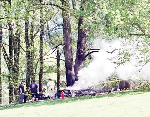 Randy Foster/editor@cherokeescout.com   Emergency responders assemble beside the burning wreckage of a Velocity airplane that crashed shortly after takeoff from Western Carolina Regional Airport on Saturday.