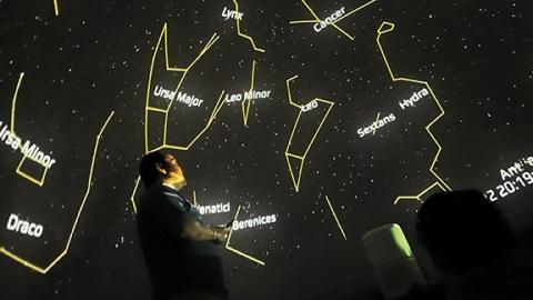Photos by Randy Foster/editor@cherokeescout.com   Top: Science education specialist Nick Eakes describes constellations that are visible in a nighttime sky. Below: Third-graders, faculty and staff in front of the mobile planetarium at Peachtree Elementary School on March 22.