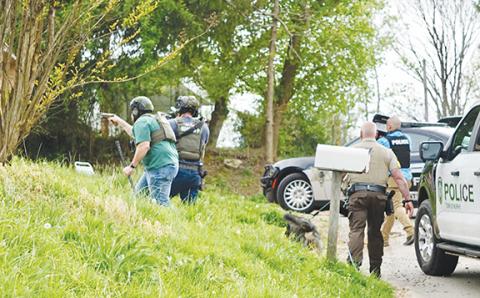 Randy Foster/editor@cherokeescout.com   Police, sheriff’s deputies and K-9 units begin approaching a house on Fort Butler Street, where they responded to a report of someone holed up and armed Thursday.
