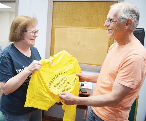 Abigail Blythe Batton/Staff Correspondent Cherokee and Clay County Senior Games & Silver Arts duo Chris and Terence Faries look over merchandise for the opening ceremony, which was held Saturday morning. See the full schedule of events at cherokeecountyseniorgames.org.