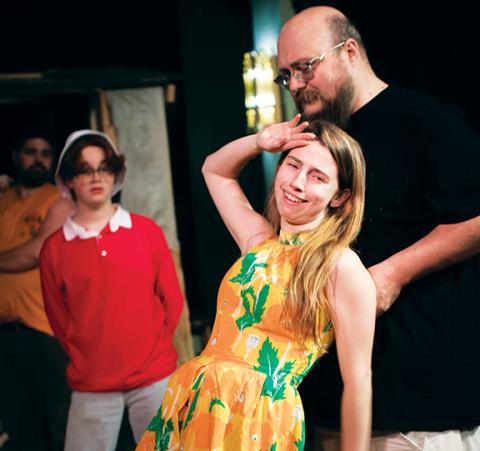 Ginger (Haley Cullpepper) faints into the Skipper’s arms (Brychan Reynolds) as Gilligan (Sawyer Bradley) looks on during a recent rehearsal at the Valleytown Cultural Arts Center in Andrews.