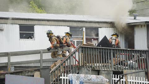 hotos by Randy Foster/editor@cherokeescout.com   Above: Murphy firefighters approach the entrance of a burning home near the intersection of Texana Road and Joe Brown Highway on Monday. 