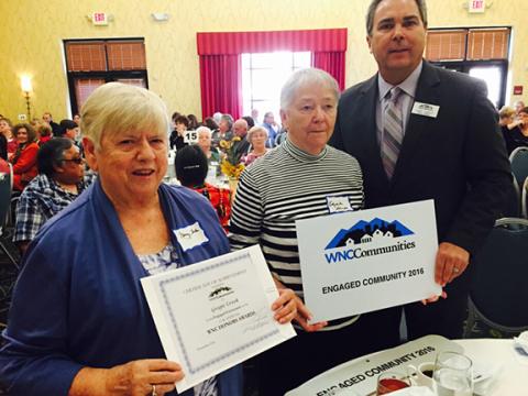 Nancy Helms, Elizabeth Sharpe and Lumpy Lambert (from left) celebrate Cherokee County’s Grape Creek at the western North Carolina community awards ceremony.