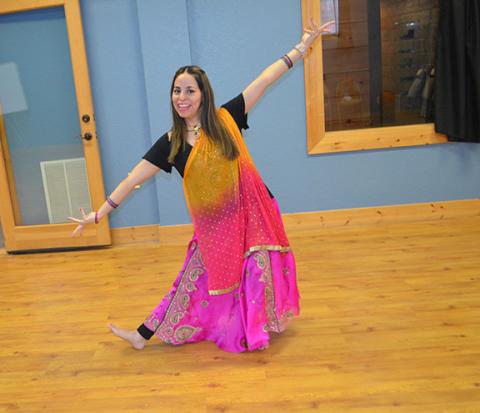  Abigail Blythe Batton/Staff Correspondent Anita Nieva-Rosas strikes a pose during a dance sequence at the Cherokee County Arts Council on Saturday as part of a free class celebrating International Dance Day.