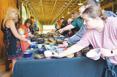 Ticket holders “shop” through more than 700 handmade bowls at the annual Empty Bowls charity event Saturday in Brasstown.