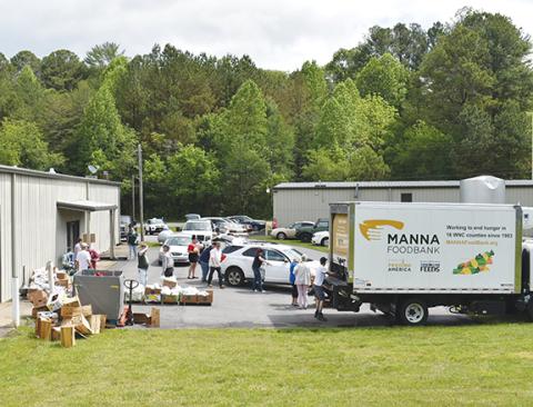 Photos Anngee Quinones-Belian/Staff Correspondent  Manna Community FoodBank and volunteers brought some relief to local residents at the Hiwassee Dam Community Center on May 17.