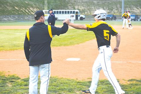 Justin Fitzgerald/sports@cherokeescout.com Murphy’s Mason Cook fist bumps his dad, Darren, after bunting for a base hit during the Bulldogs’ 8-1 loss at Swain County on Thursday.