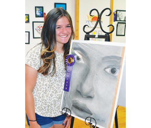 Photos by Abigail Blythe Batton/Staff Correspondent Carlee Catuto, a Murphy High School senior, won Best in Show at the Cherokee County Arts Council on April 21 with her charcoal painting, “The Woman.”