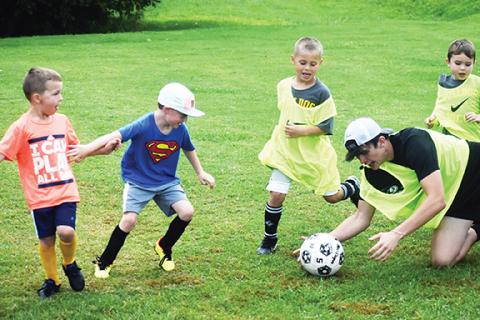 Photos by Justin Fitzgerald/sports@cherokeescout.com Murphy soccer hosted its eighth annual youth soccer camp for kids ages 5-14 on June 19, 21 and 22 at the Lowe’s Soccer Field. Despite the rain throughout the week, fun was had by all. Above: Murphy sophomore Joey Gibby saves the ball from an onslaught of some of the youngest campers during a scrimmage on June 21. 