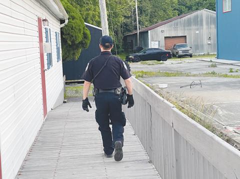 Photos by Randy Foster/editor@cherokeescout.com Murphy police Cpl. Adam May checks for signs of break-ins at a vacant commercial building Friday. 