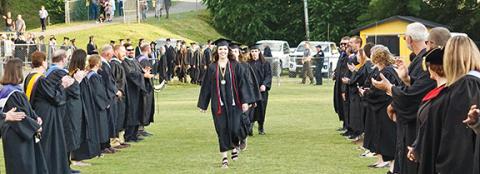 Photos by Randy Foster/editor@cherokeescout.com Graduating seniors, cheered on by Murphy High School’s faculty and staff, make their way onto David Gentry Field at Bob Hendrix Stadium during Friday night’s commencement.