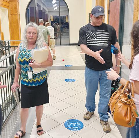 Randy Foster/editor@cherokeescout.com Teresa Ricks, with her husband David Ricks, greet well-wishers following a June 5 decision by the Cherokee County Board of Commissioners to keep her on as the county’s tax assessor.
