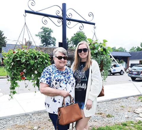 Lynn Bogle and Avery Gardner enjoy the hanging baskets in Andrews.