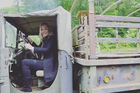 Abigail Blythe Batton sits inside a truck that was actually used during the Vietnam War.