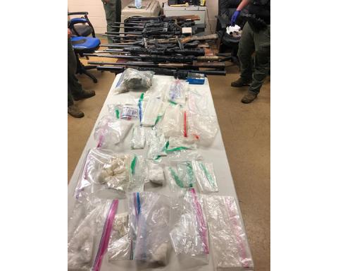 Cherokee County Sheriff’s Office An evidence photo shows weapons and suspected drugs seized by local law enforcement.