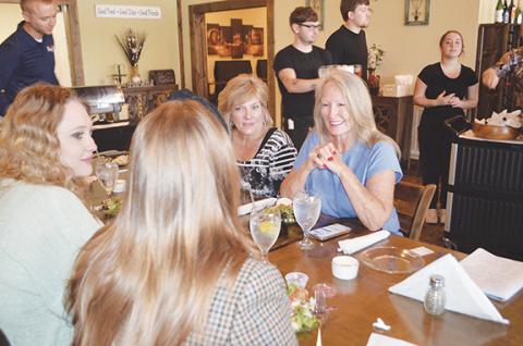 Abigail Blythe Batton/Staff Correspondent Exit Realty broker Kathy Vetton speaks with her team of real estate agents during the Mountain Lakes Board of Realtors meeting May 16 at Legends Steak House in Murphy.