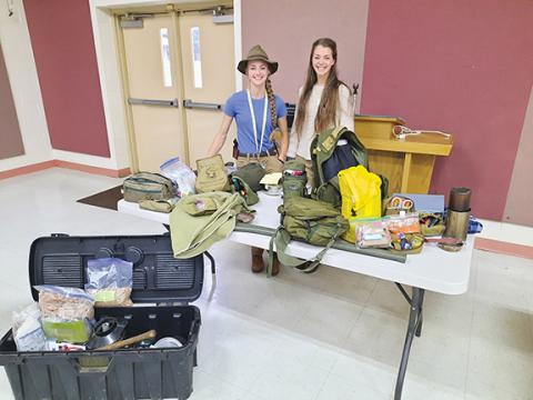 Anngee Quinones-Belian/Staff Correspondent  Abigail and her sister, Emily Hays, teach the group how to make various types of survival bags – just in case.