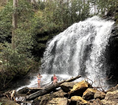 The Cover Falls is located on Brittain Creek. Two children are enjoying the roar of the falling water and the constant mist as it tumbles down the rocks. An old trail goes to the cave up on the cliff to the left of the falls.  