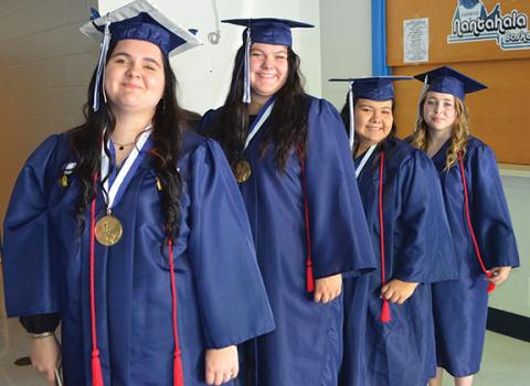Photos by Abigail Blythe Batton/Staff Correspondent The final seconds before they became Nantahala School graduates, Madysson Gray, Daphne McCoy, Samantha Pendergrass and Kristin Postell line to march for their commencement Friday night.