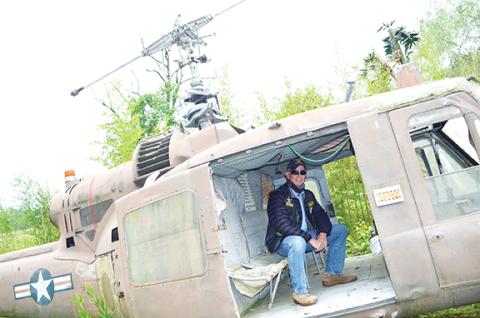 Abigail Blythe Batton/Staff Correspondent Dave “Scout” Nelson sits in the back of a UH-1 Iroquois helicopter at Roger Swanson’s Band of Brothers Veterans Park in Murphy.