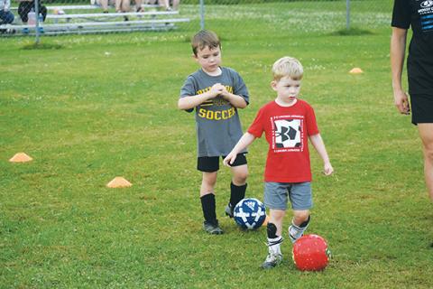 Justin Fitzgerald/sports@cherokeescout.com Rylan Golden (left) and Holden Clonts (right) dribble through the cones during the Murphy Soccer Youth Camp on June 21.