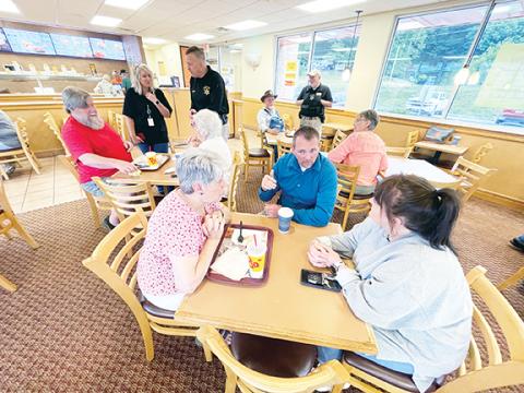 Randy Foster/editor@cherokeescout.com Suzi Perkins, Cherokee County Sheriff Dustin Smith and Kadee Close (from left) chat over coffee during a Coffee with a Cop event at Bojangles in Murphy on Friday.