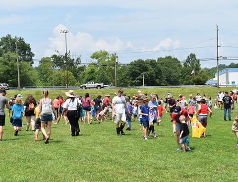 Bill Belian/Contributing Photographer  Folks rushed onto the field at Konehete Veterans Park for the popular Peanut Drop during the Cherokee County’s Hometown Celebration on July 1.