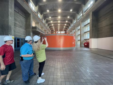 Civilians take pictures of electric generators during a tour of Fontana Dam on July 28. 