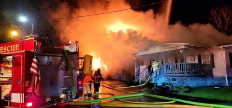 Firefighters from Andrews, Murphy and Peachtree battle a blaze at 52 Robbinsville Road on July 23. Photo by Robert Graf/Valleytown Fire & Rescue