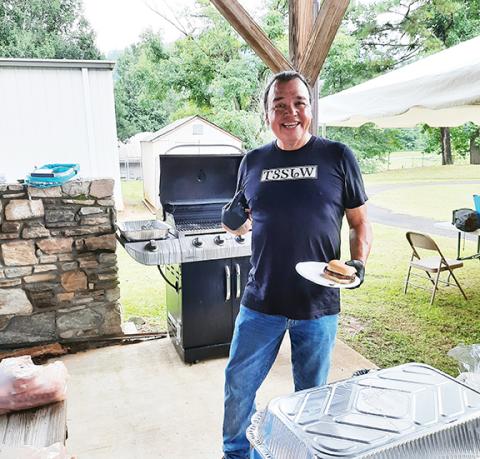 Anngee Quinones-Belian/ Staff Correspondent  Well-known James “Bo” Taylor, a Cherokee dancer and storyteller, was also busy grilling burgers and hot dogs during the health fair at the Marble Community Center on Thursday.