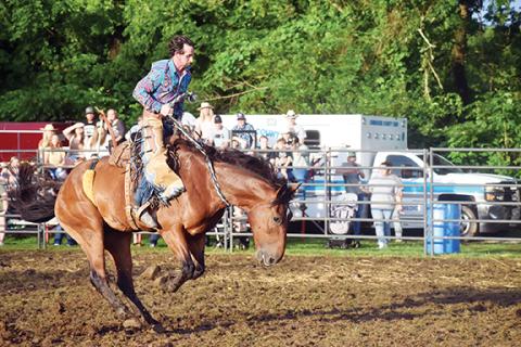 Photos by Justin Fitzgerald/sports@cherokeescout.com Matt Seymour tries to stay on his horse during the Ranch Bronco event at the Great American Rodeo Company rodeo in Andrews on Saturday night;