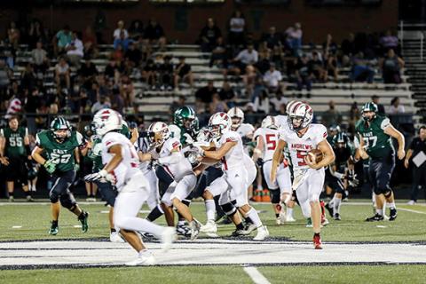 Haley West/Contributing Photographer Andrews Dalton Rose looks for a hole to run through during the Wildcats 54-30 win at East Henderson on Aug. 25.