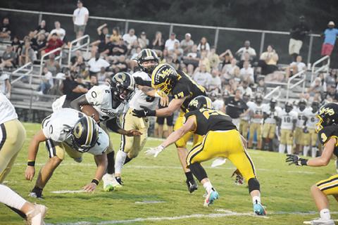 Justin Fitzgerald/sports@cherokeescout.com Murphy’s Brayden Killian (17) and Hunter Stalcup (28) try to get a hand on Commerce running back Jacari Huff in the second quarter of the Bulldogs 56-13 loss to the Tigers on August 25.