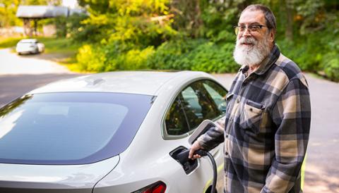 Student and archives volunteer Steve Byers charges his fully electric BMW at John C. Campbell Folk School’s new charging station in Brasstown.