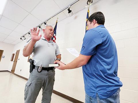 Randy Foster/editor@cherokeescout.com Andrews Interim Police Chief David Southards (left) is administered the oath of office by Town Clerk Ethan McCubbin at the facilities building Friday.