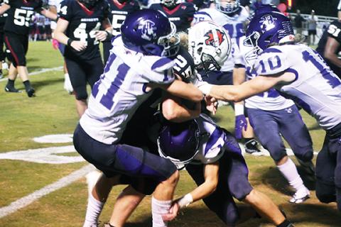 Justin Fitzgerald/sports@cherokeescout.com Andrews’ Holden Todd fights for extra yards against Mitchell’s defense during the Wildcats’ 20-3 loss to the Mountaineers on Friday night.