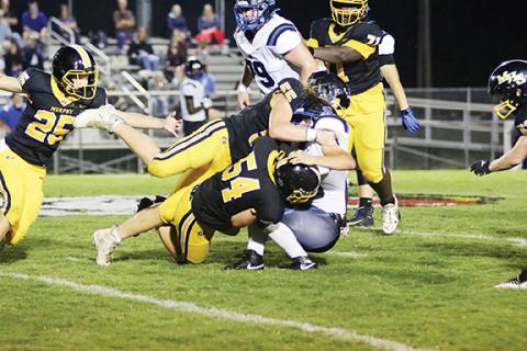 Dave Guffey/Contributing Photographer Murphy’s Charlie Graves (54) and Brody Orton (55) team up to make a big hit during the Bulldogs’ 49-27 win Friday night, the team’s first of the 2023 season.