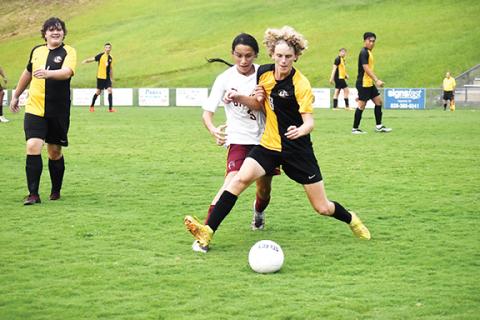 Photos by Justin Fitzgerald/sports@cherokeescout.com Murphy’s Tyler Payne battles for the ball with Cherokee’s Utsela Saunooke during the Bulldogs’ 10-1 win over the Braves on Sept. 6.