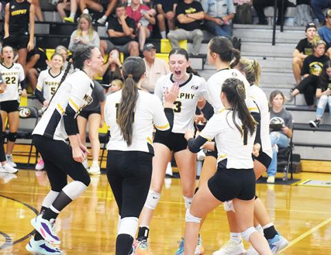 Justin Fitzgerald/sports@cherokeescout.com Murphy’s Cali Rumfelt celebrates a kill with her fellow teammates during the Lady Bulldogs’ four-set loss to Robbinsville on Aug. 29.