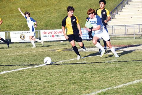 Justin Fitzgerald/sports@cherokeescout.com Tri-County Early College’s Andrew White tries to get past Murphy’s Kole Ritz during the Jaguars’ 5-0 loss to the Bulldogs on Sept. 20.