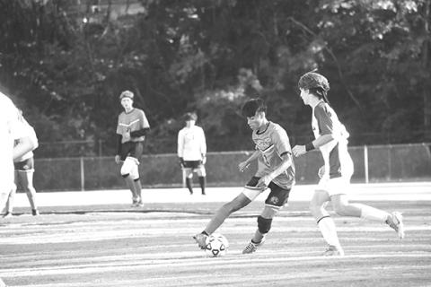 Justin Fitzgerald/sports@cherokeescout.com Andrews’ Joshua Hernandez dribbles the ball around the Tri-County’s Logan DiCicco in the Wildcats’ 4-0 win over the Jaguars on Thursday.