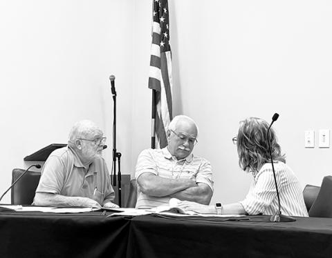 Randy Foster/editor@cherokeescout.com Jerry Decker, Alex Starks and Teresa Oblenes (from left), members of the Cherokee County Board of Equalization & Review, huddle to discuss an appeal of a $488 tax bill against Joe and Cherokee County Commissioner Jan Griggs at the county court house on Sept. 7.