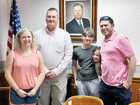 Chad Simons/Contributing Photographer  The Sharpe family from England first visited Murphy in 2019, falling in love with the flowers as well as the town. They recently visited again and would like to move to Murphy one day. From left are Kate Sharpe, Murphy Mayor Tim Radford, Jude Sharpe, Fleur Sharpe and Brandon Sharpe.