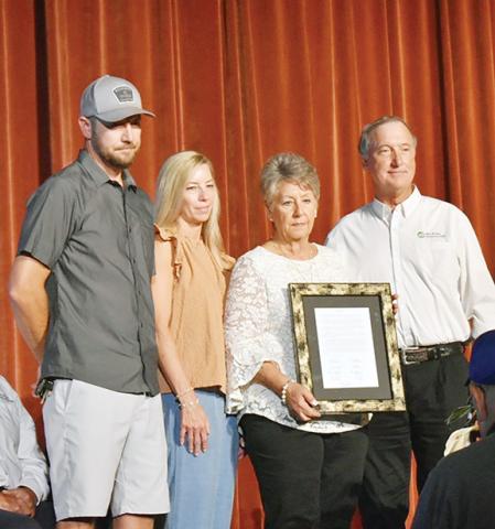 Photos by Bill Belian/Contributing Photographer  The Satterfield family accepts a framed Resolution on behalf of Roy G. “Joe” Satterfield for his years of service and dedication to Blue Ridge Mountain Electric Membership Corp. The resolution was presented by Roy Perren, president of the board of directors (far right).