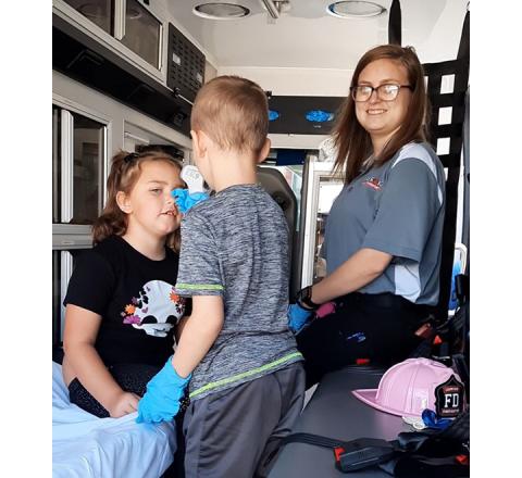 Bill Belian/Contributing Photographer  Kids pretend to be both emergency personnel and patients in the back of a Prestige Patient Transport vehicle at the Ranger Volunteer Fire Department event Oct. 14. From left are Harper Messer, Shaun Stiles and Elizabeth Watkins, an advanced EMT with Prestige.