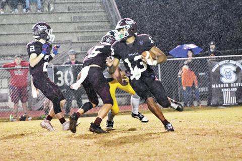 Joanna McMahan/Contributing Photographer Glaspie carries the ball in Friday night’s game against Murphy, which the Maroon Devils beat 37-13.