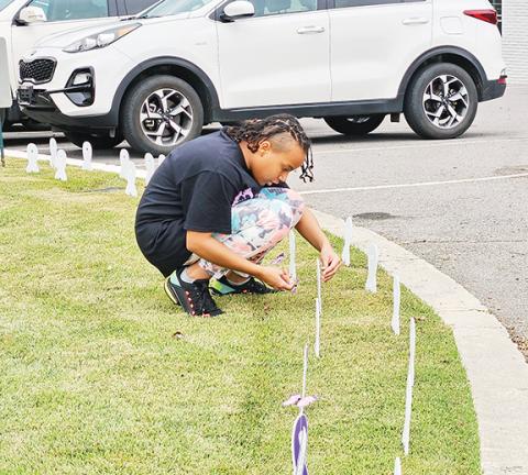 Local residents fighting back place memorials to victims of domestic violence at First United Methodist Church in downtown Murphy on Friday.