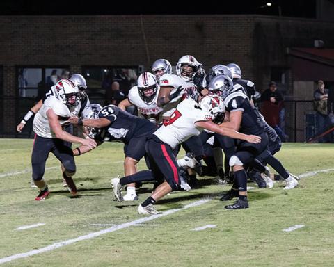 Maria Shook/Contributing Photographer Andrews’ Kencade Watkins (8) halts the progress of Robbinsville’s Cuttler Adams during the Wildcats’ 36-19 road loss to the Black Knights on Friday. 