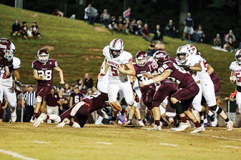 Haley West/Contributing Photographer Andrews’ Dalton Rose tries to run past several Swain County defenders during the Wildcats’ 20-0 loss at the Maroon Devils on Friday night.